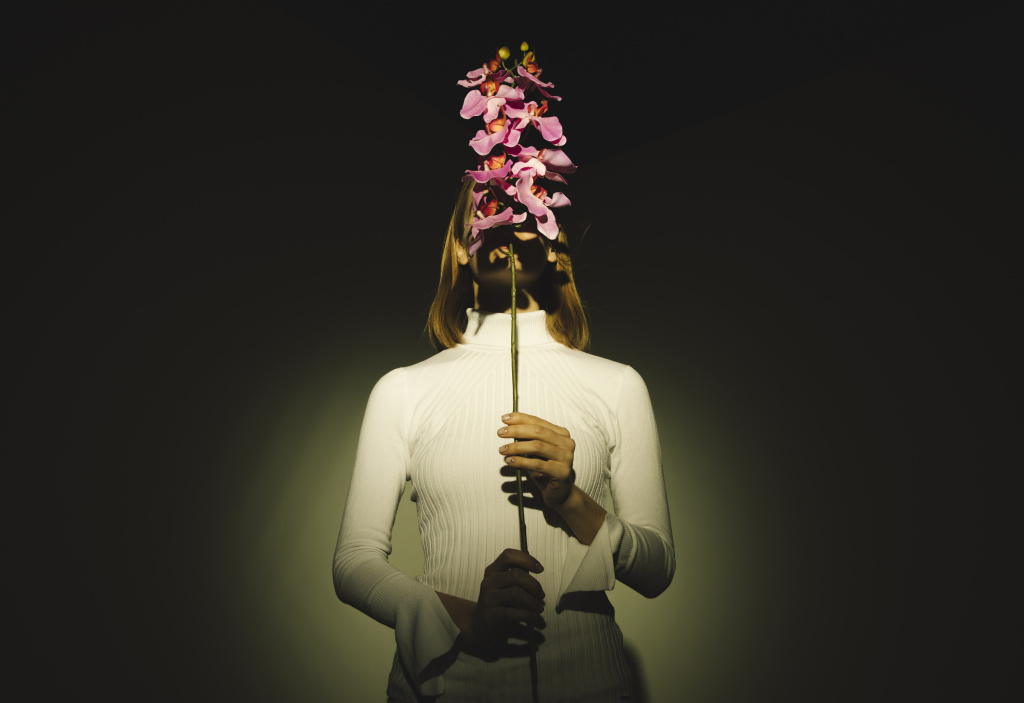 woman-covering-face-with-pink-flower.jpg